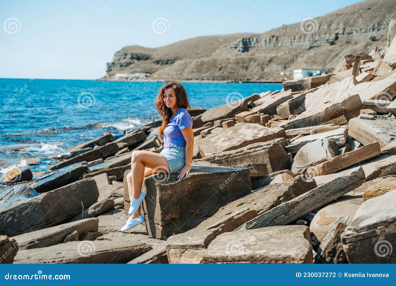 Una Joven En Pantalones Cortos En Una Playa Rocosa Hecha De Piedras  Naturales En Crimea Un Paisaje Lúgubre Icelandio Foto de archivo - Imagen  de cubo, azul: 230037272