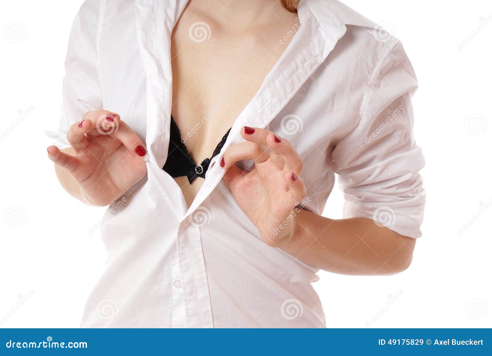 Photo about Unrecognizable woman unbuttoning blouse revealing her bra. 