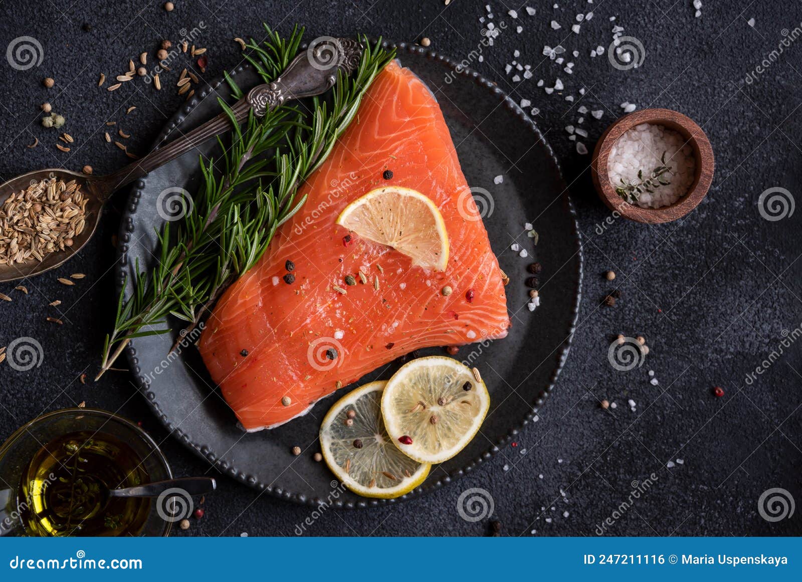 Uncooked Raw Salmon Fish with Herbs on Dark Background Stock Photo