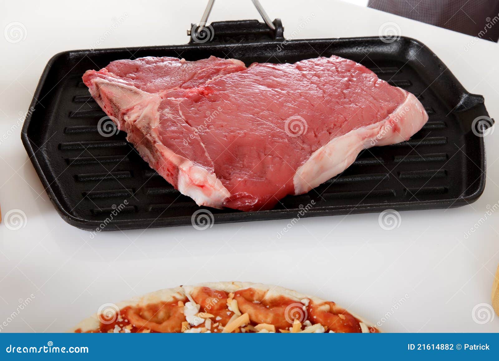 Uncooked steak on grill. stock photo. Image of surface - 21614882