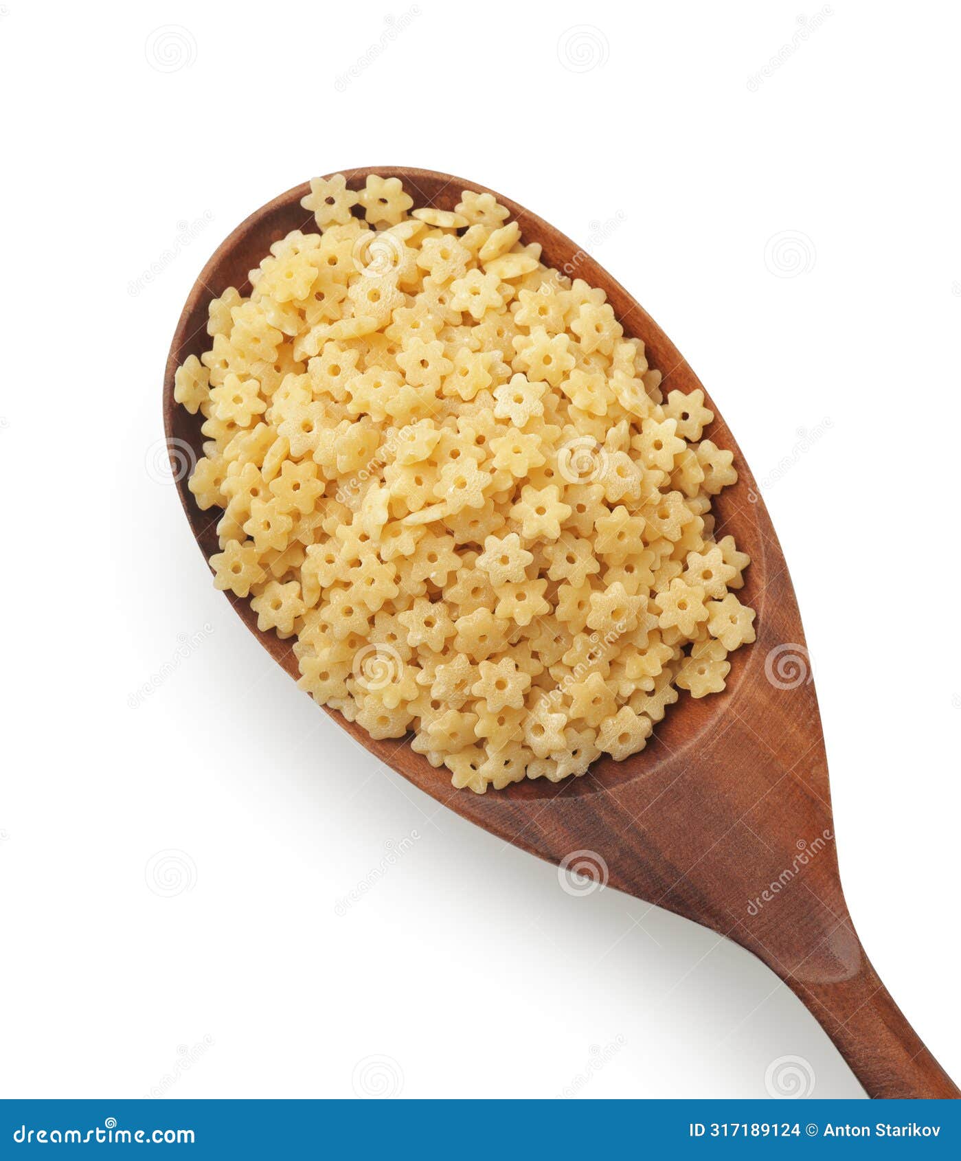 uncooked stelline pasta in wooden spoon