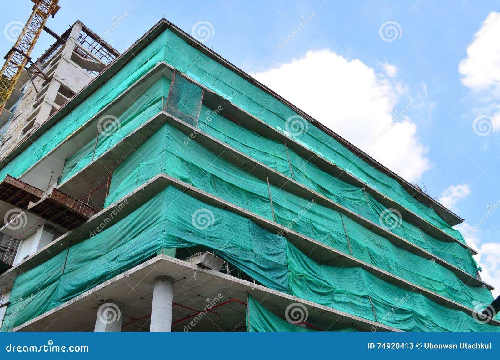 under construction building covered with green net for safety