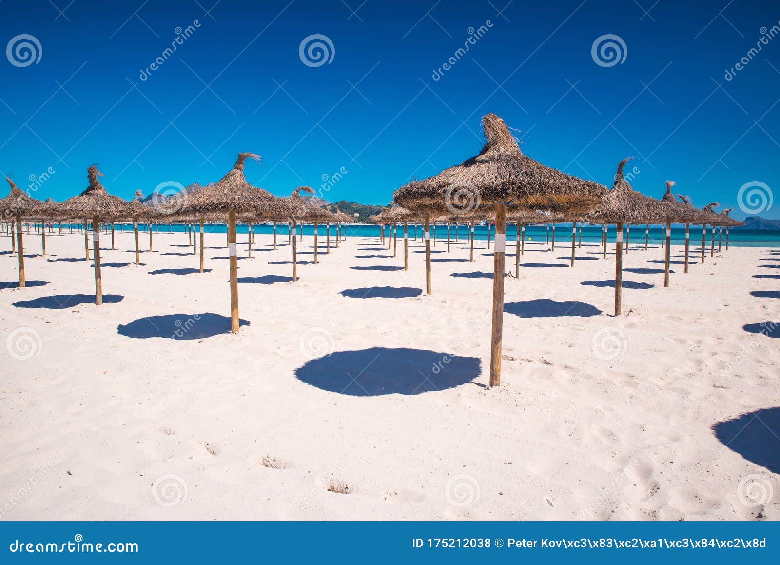 under umbrellas at arenal beach playa de palma. mallorca, spain, summer holiday photo