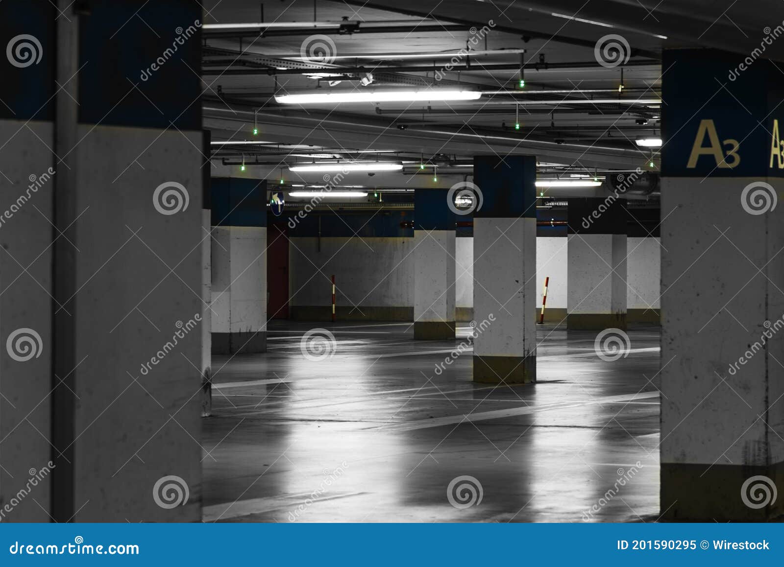Underground Parking Area with Lighting and White Pillars Stock Image