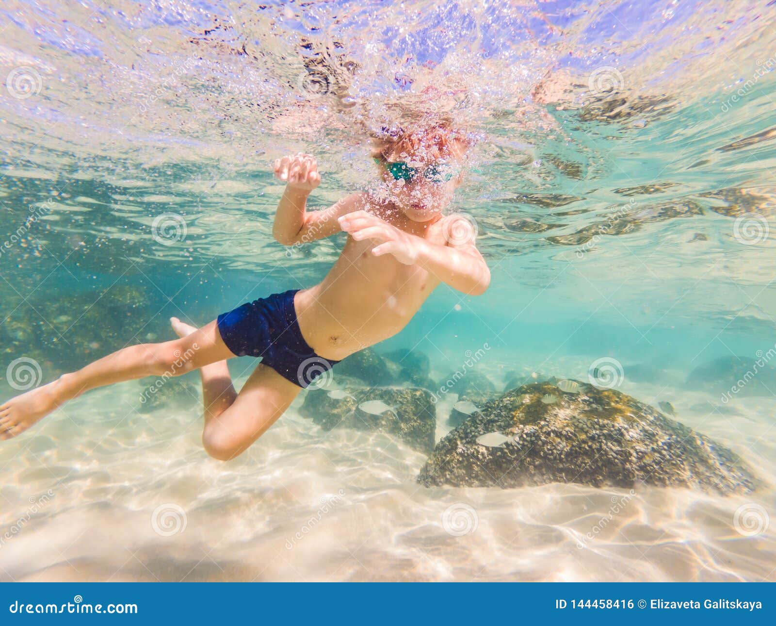 Underwater Nature Study, Boy Snorkeling in Clear Blue Sea Stock Photo