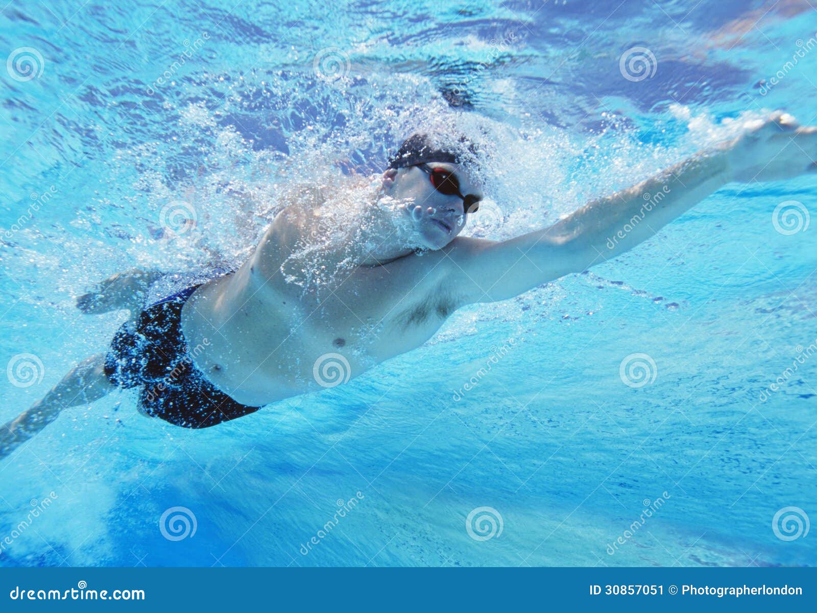 underwater shot of professional male athlete swimming in pool