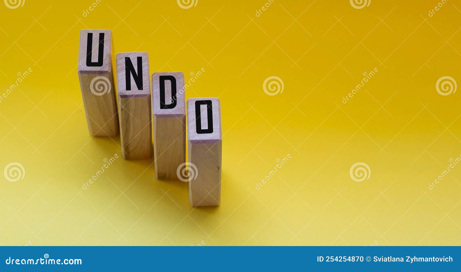 undo word on wooden cubes with letters on yellow background. the concept of a computer program technical issue. concept of