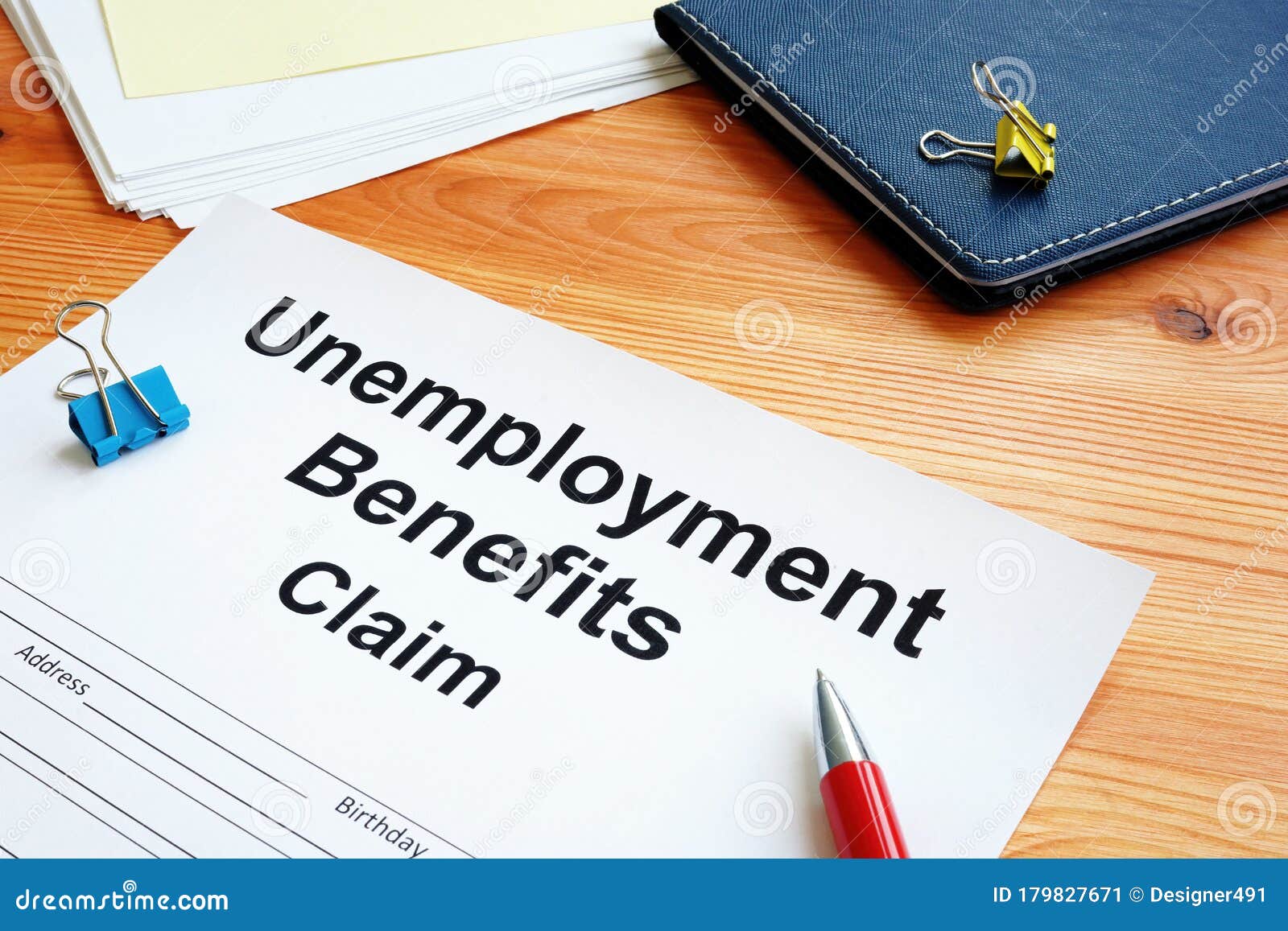 unemployment benefits claim and stack of papers