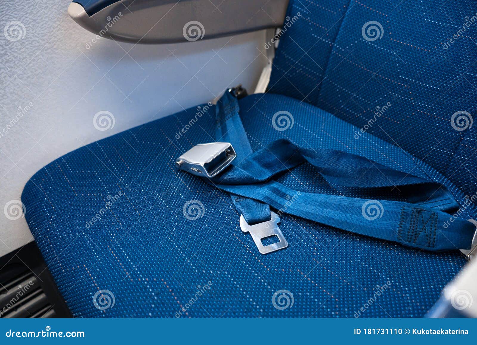 An Unfastened Seat Belt on an Empty Seat in an Airplane. Safety in