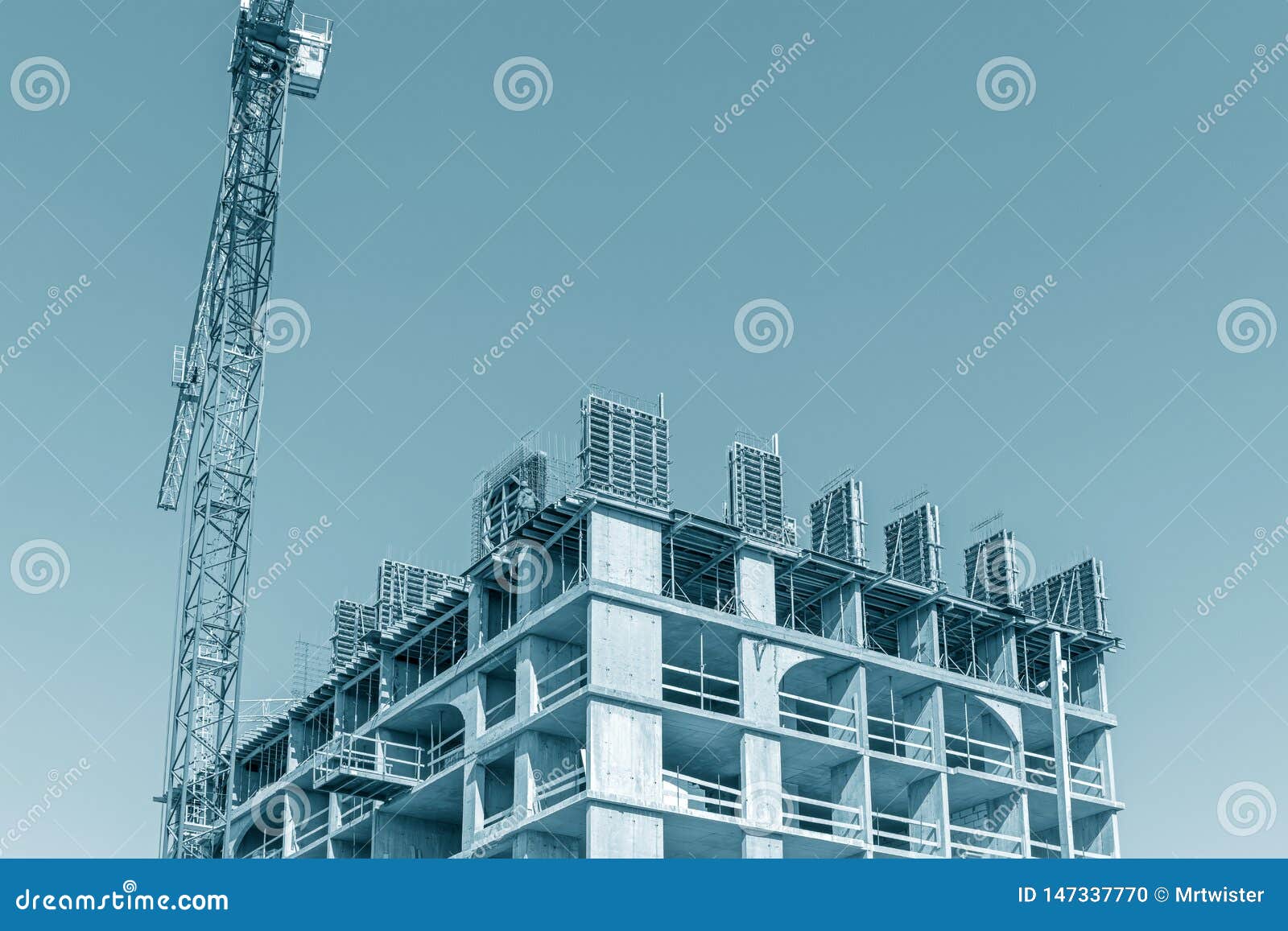 unfinished building with falsework against blue sky background