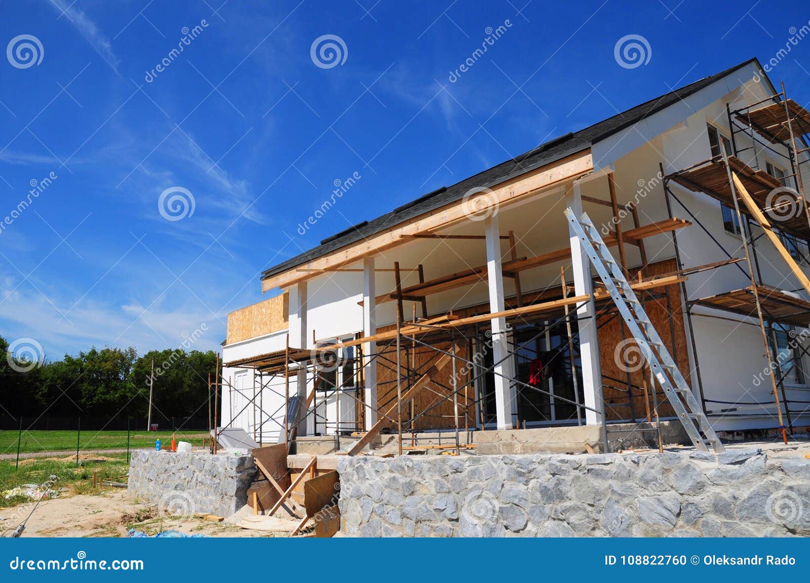 unfinished house. home remodeling and renovation. painting house wall with stucco and plastering. insulation house wall
