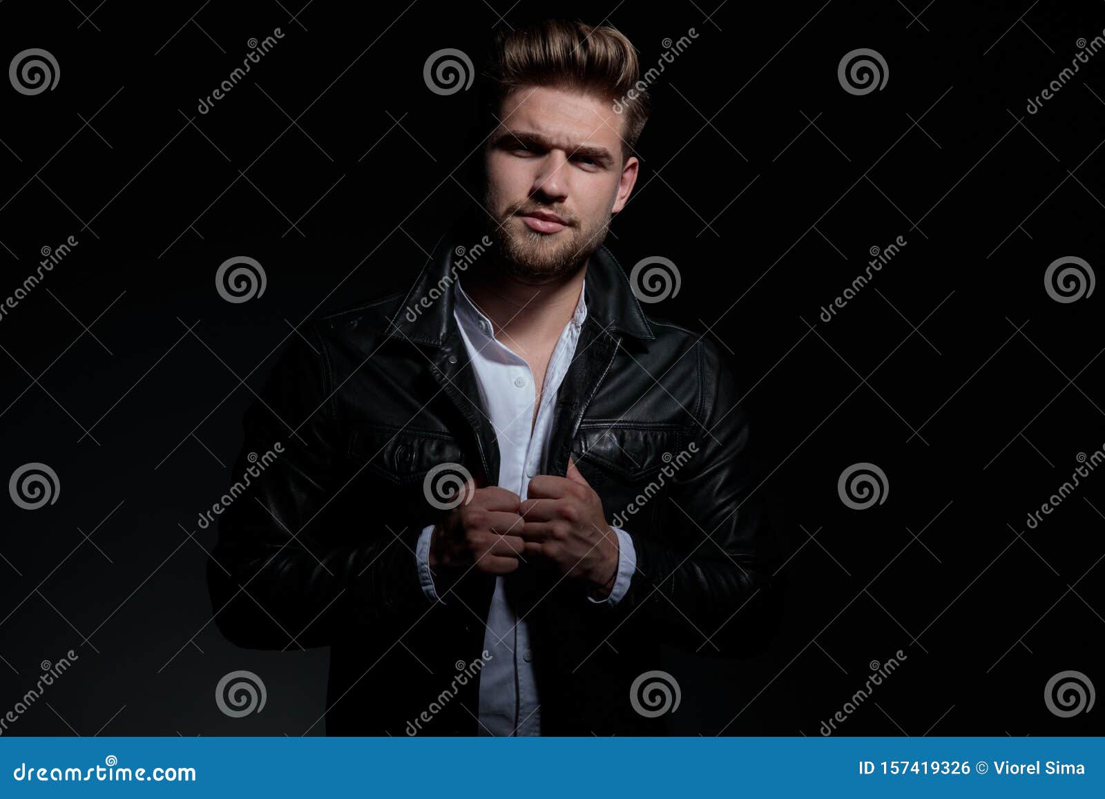 Unhappy Of Angry Young Man Holding His Leather Jacket`s Collar Stock ...
