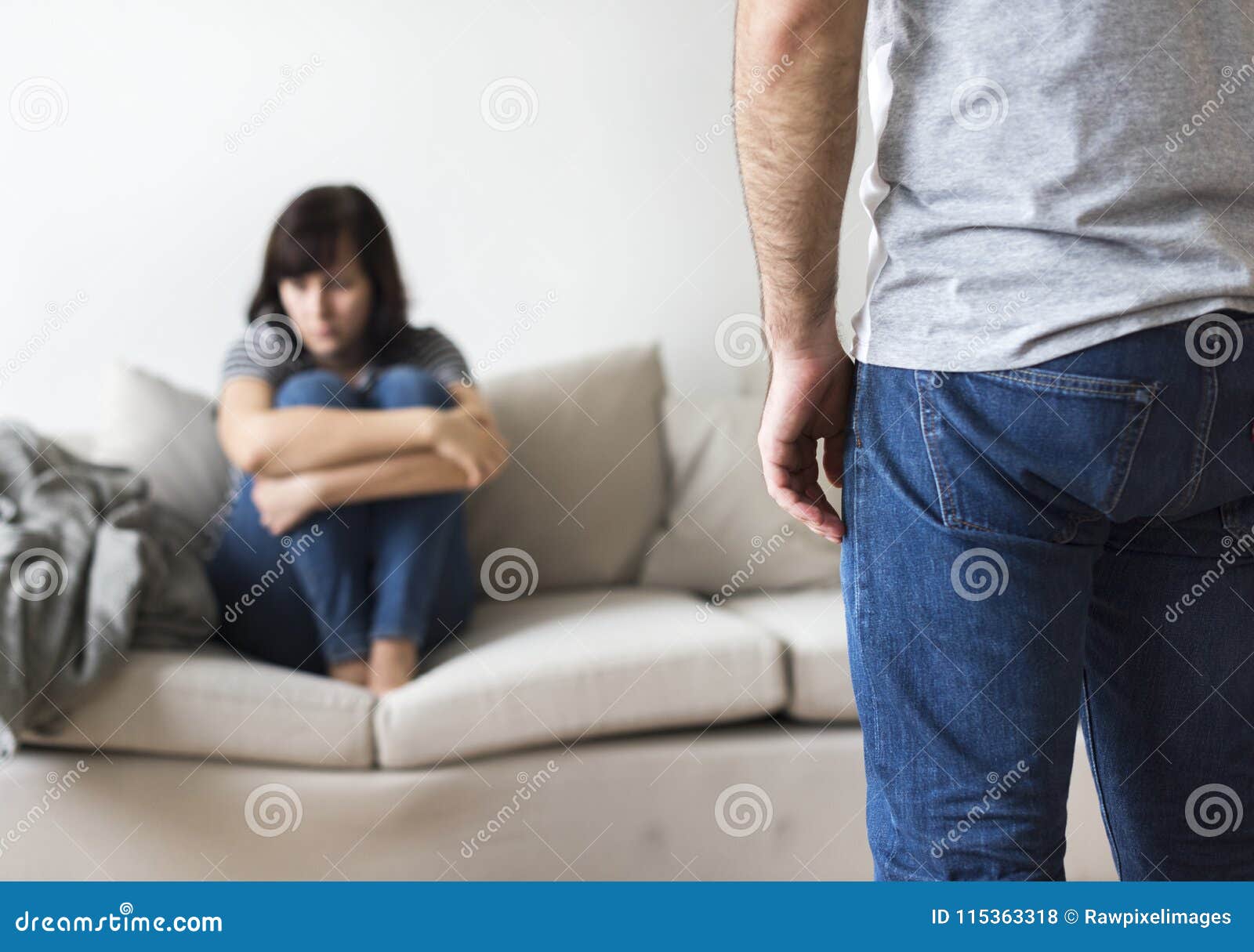 unhappy couple arguing on the sofa
