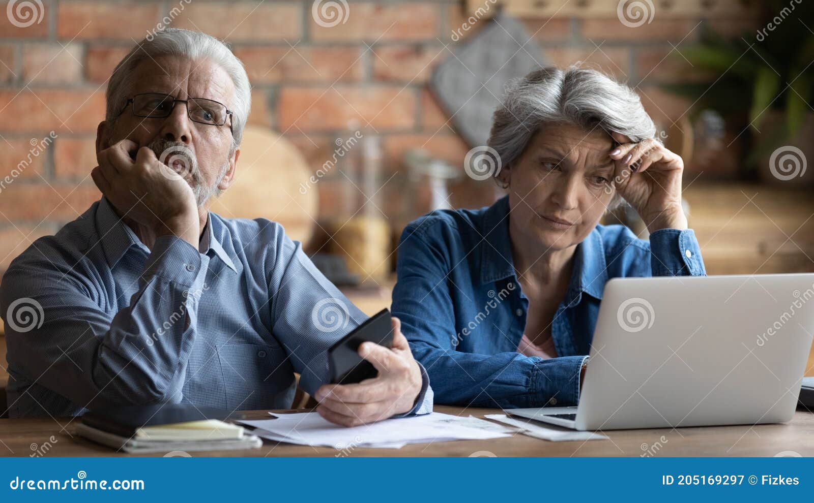 unhappy older senior family couple thinking of financial problems.