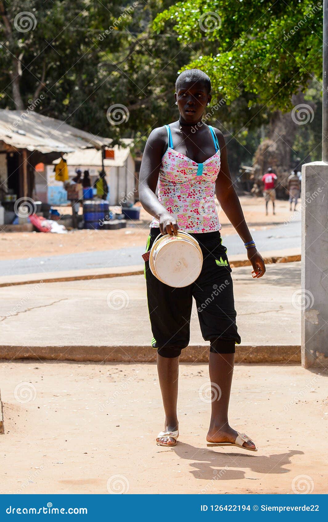 Unidentified Local Woman Carries A Bucket In A Village In Guine Editorial Stock Image Image Of