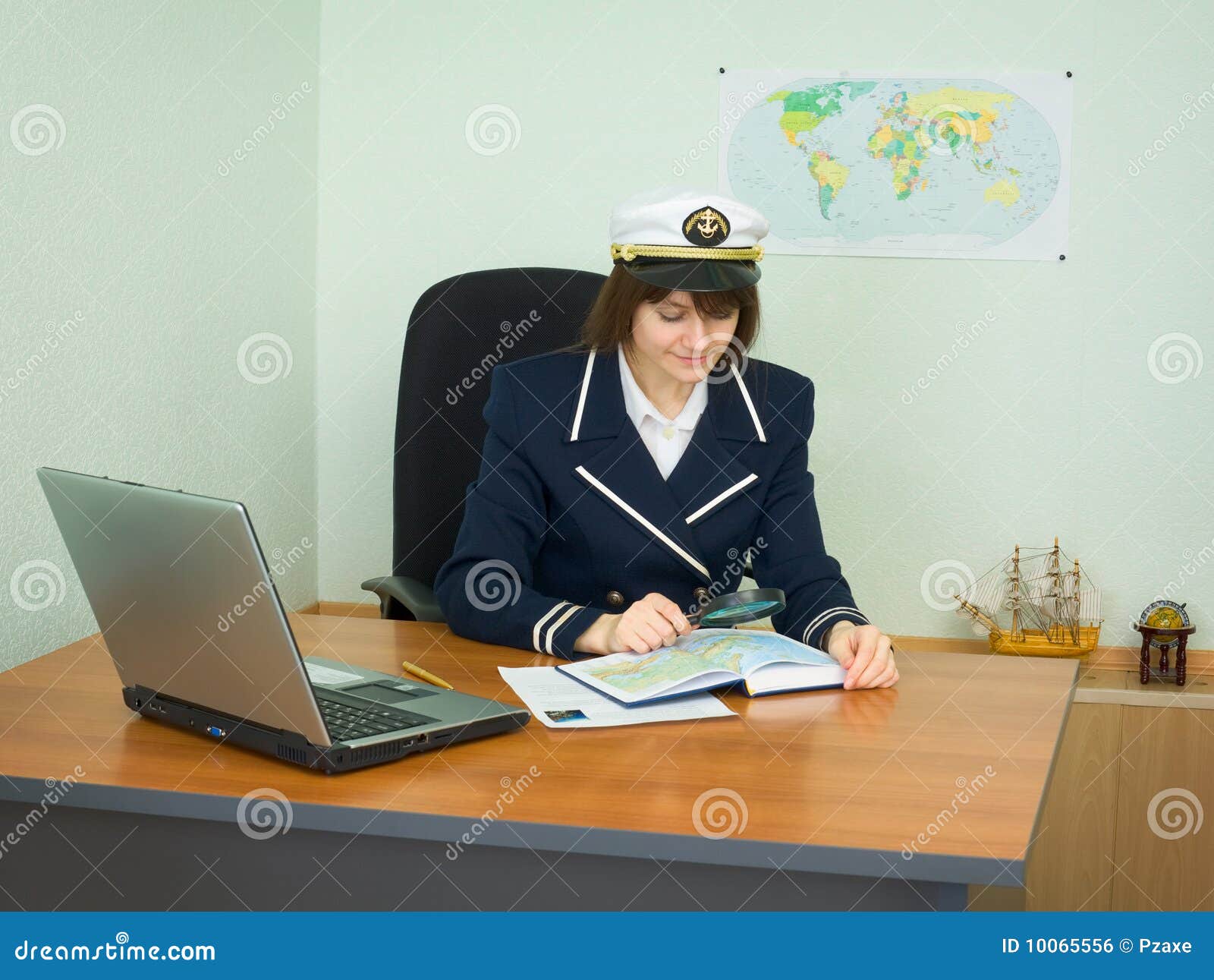 in uniform of captain examines geographical
