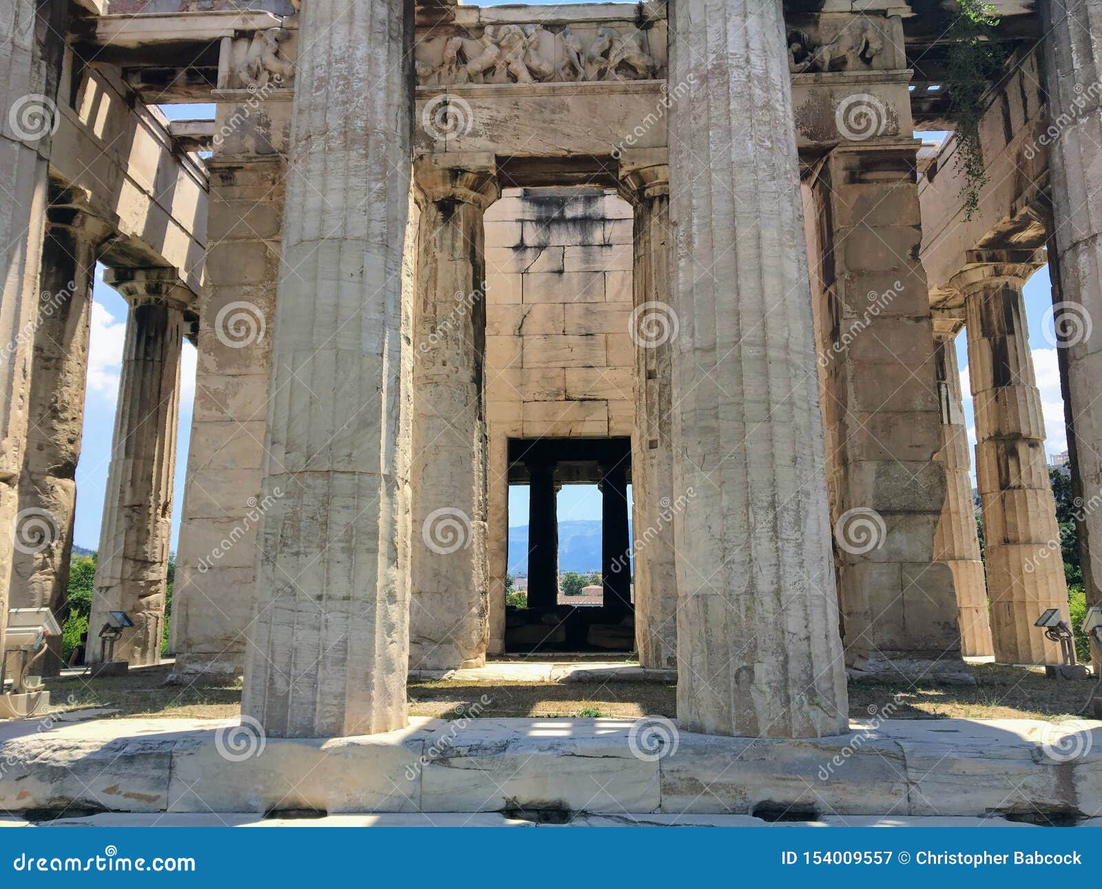 a unique view looking through the columns of the doric columns of the temple of hephaestus or hephaisteion