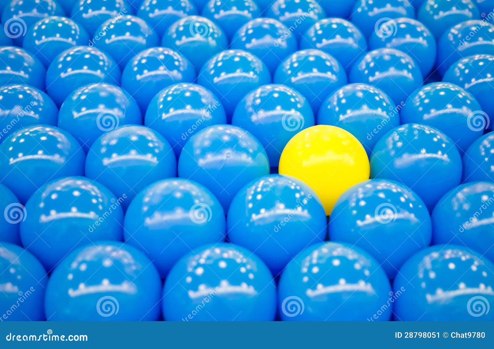 unique yellow ball among blue balls