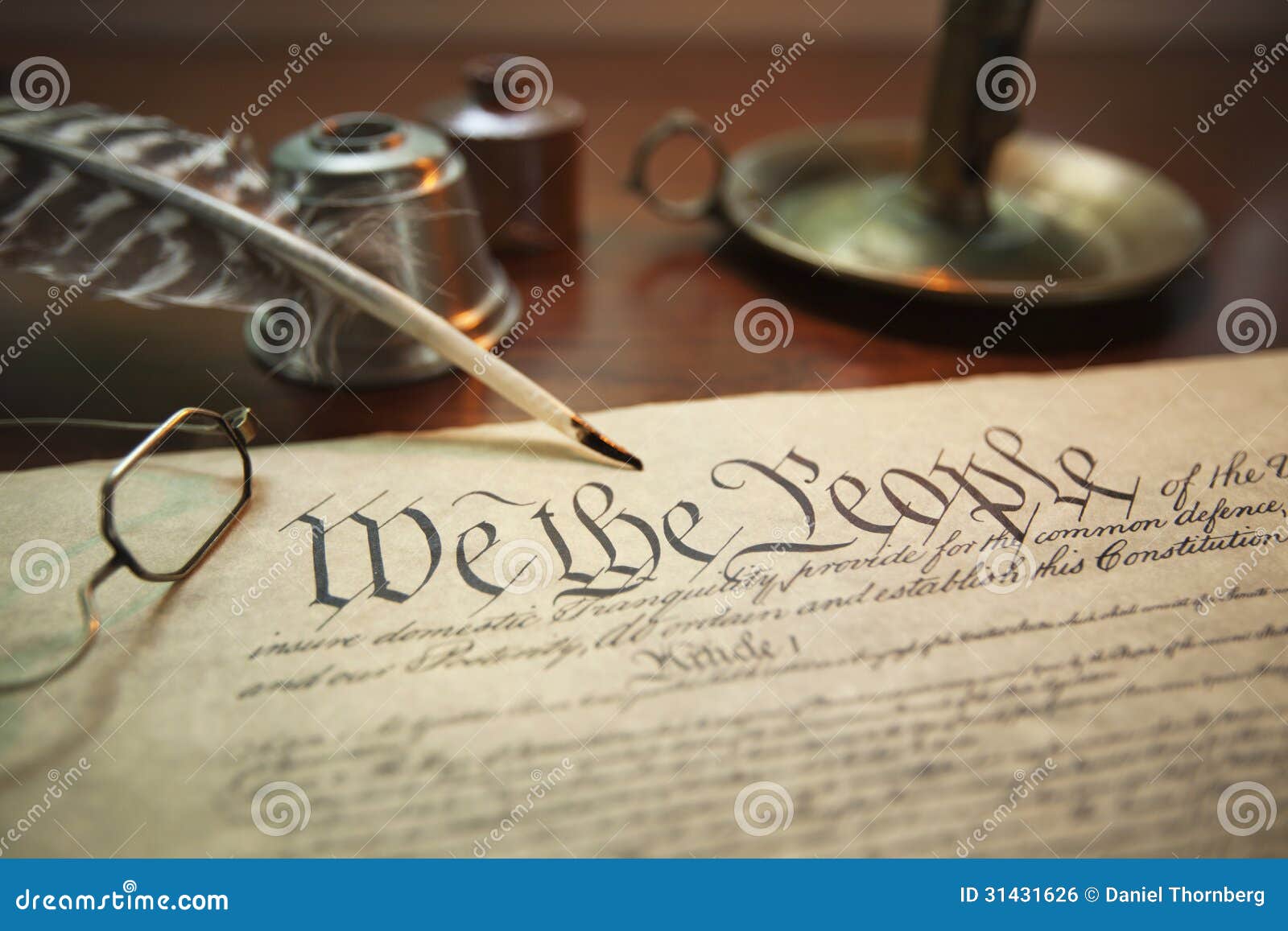 united states constitution with quill, glasses and candle holder