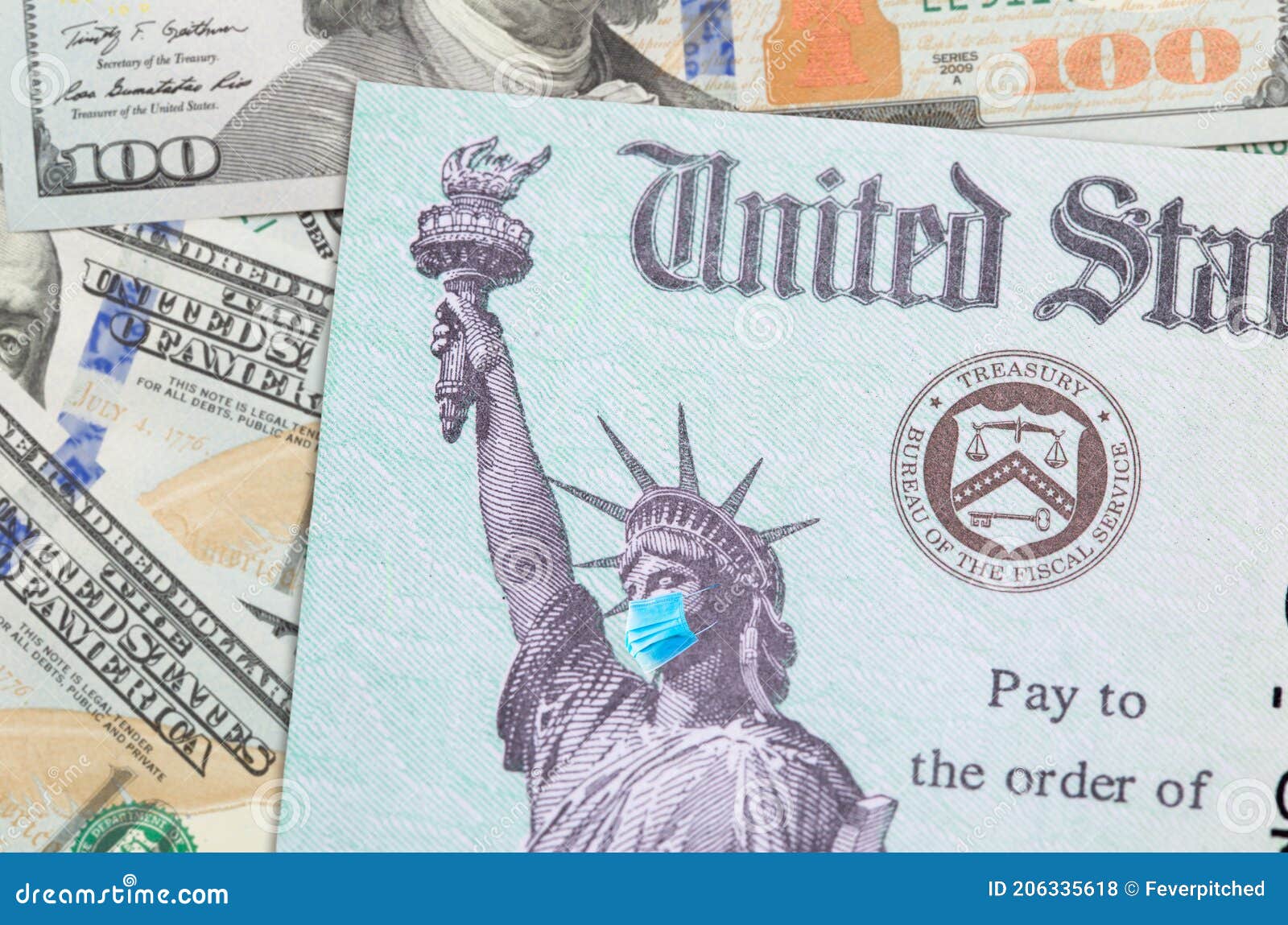 united states irs stimulus check with statue of liberty wearing medical face mask resting on money