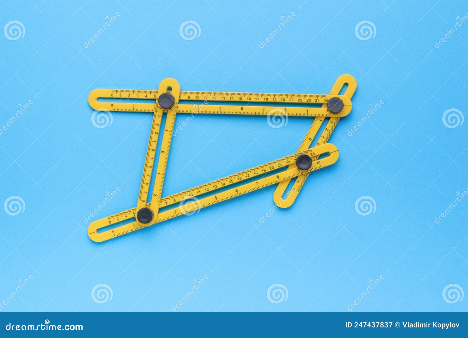 universal construction ruler for measuring dimensions and angles on a blue background. minimal concept of measuring instruments