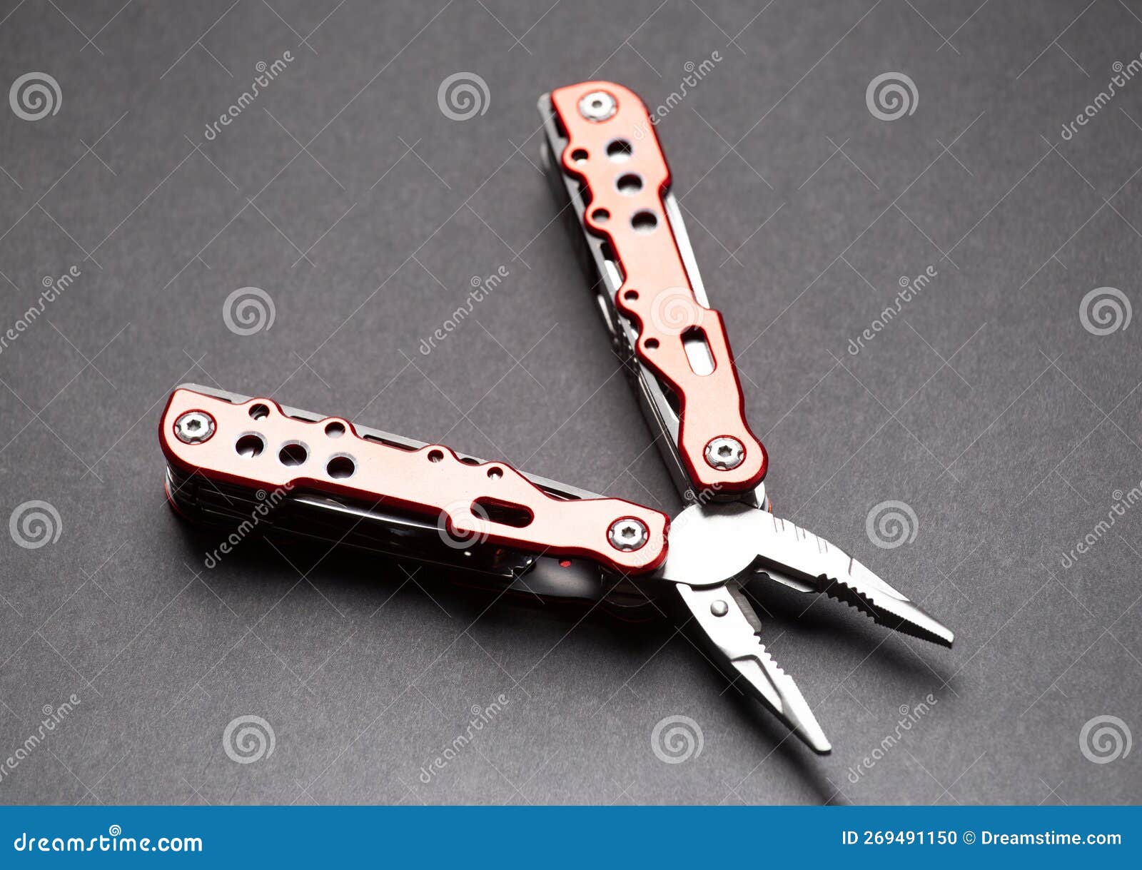 Utility Tool Knife with Pliers and Nozzles on a Gray Background Stock