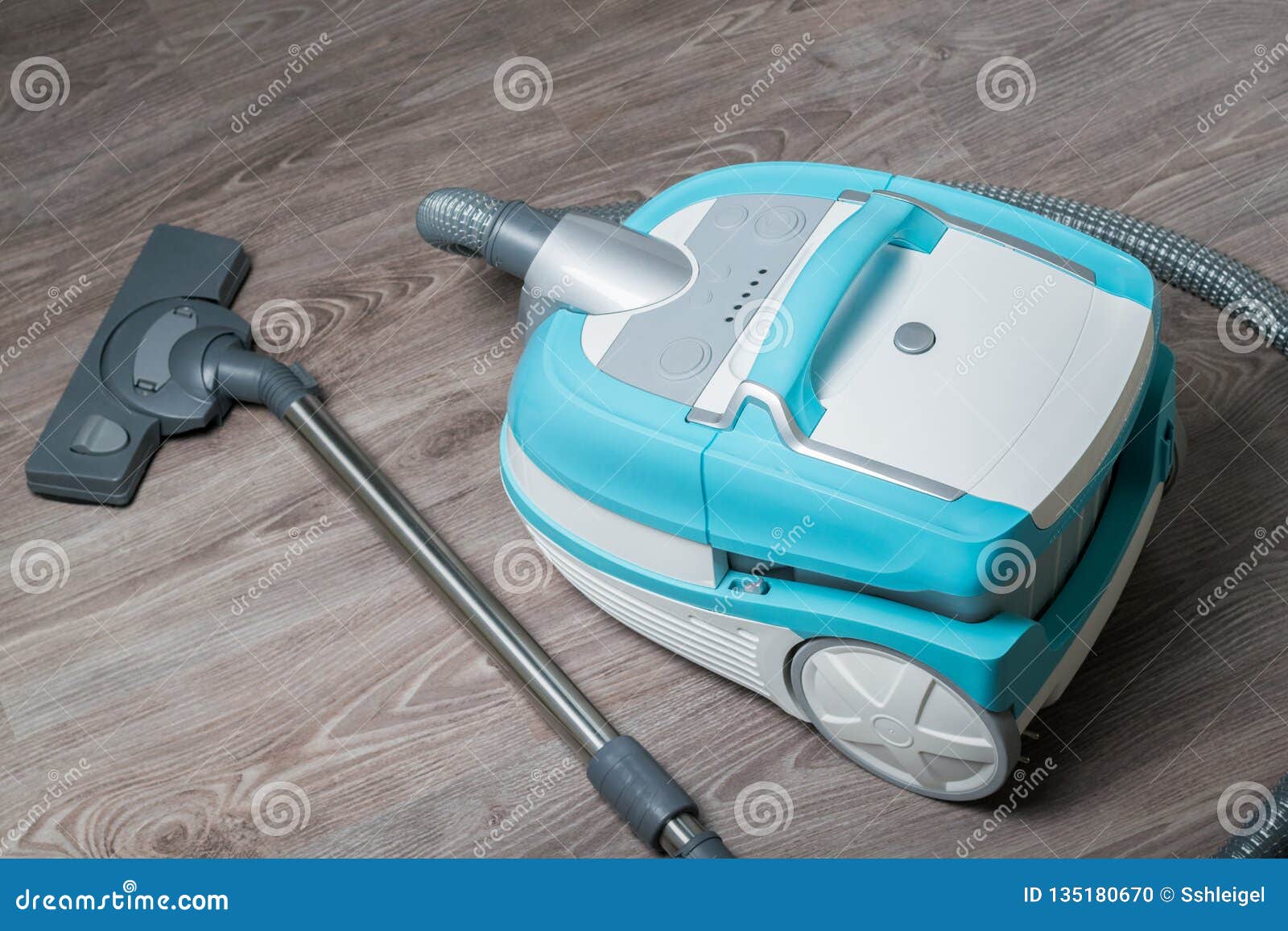 Universal Vacuum Cleaner on a Laminate Floor Shot from Above Stock
