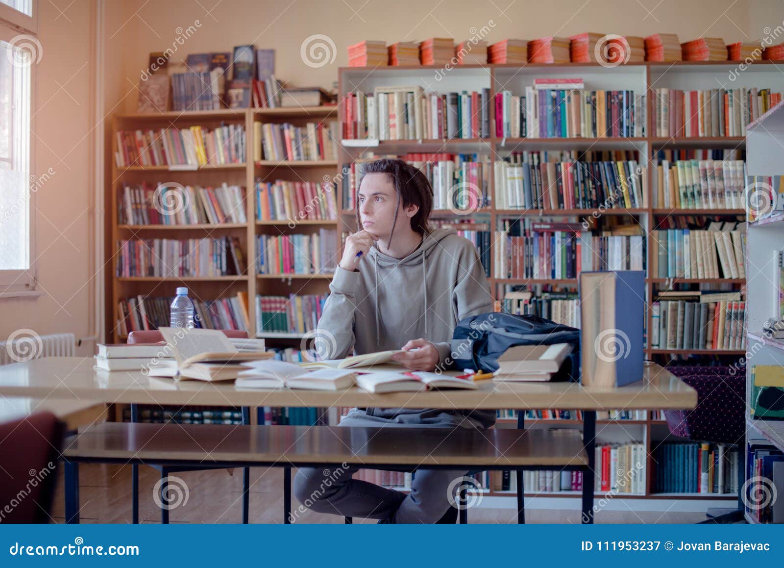 University Student Daydreaming in Library. Stock Image Image of desk