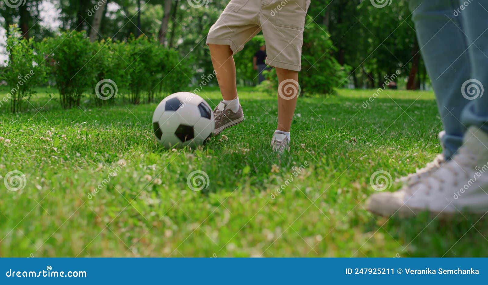 Faceless person standing with soccer ball between legs on grass · Free  Stock Photo