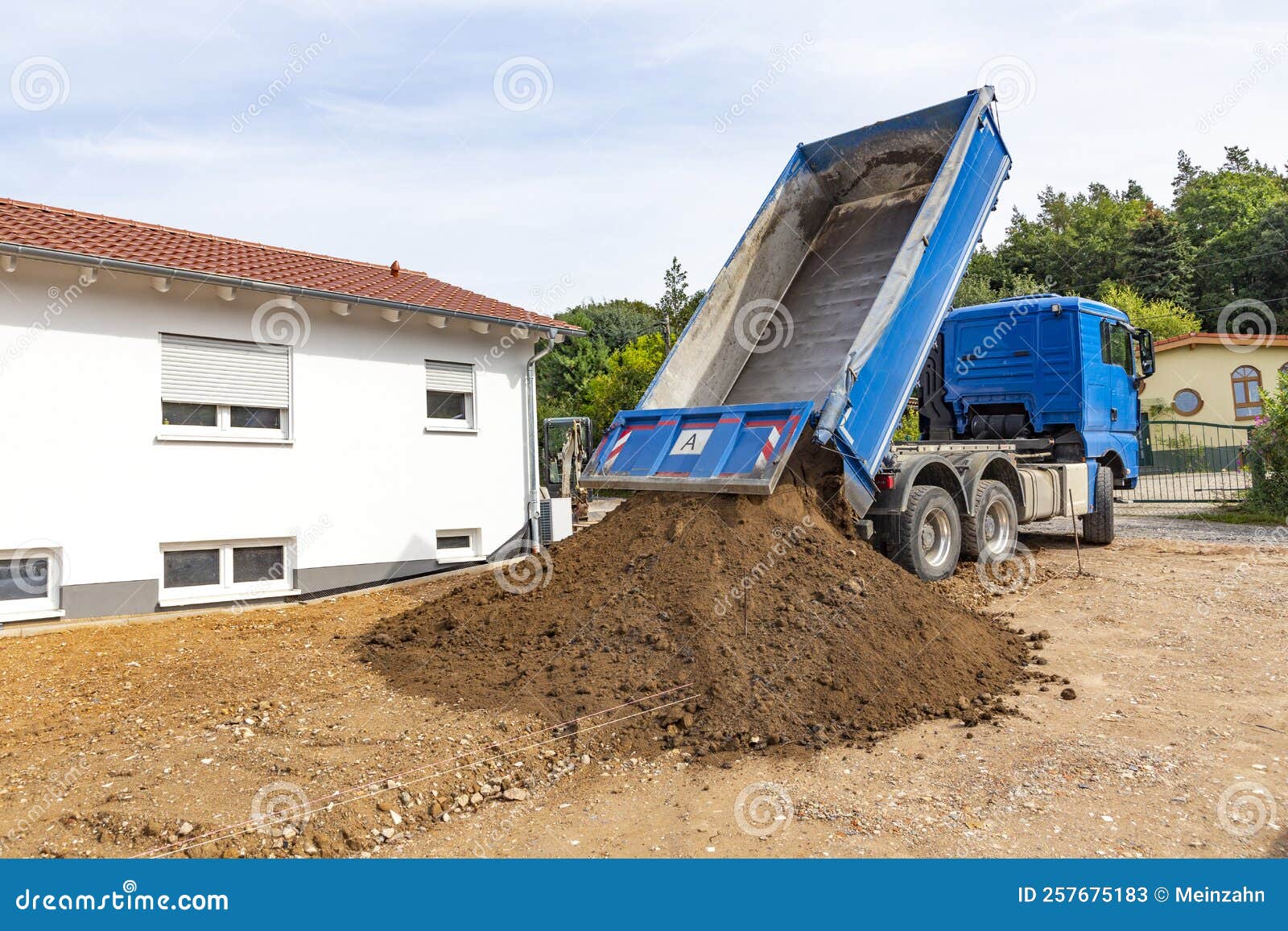 Unloading the Truck with Potting Soil from the Truck Bed at the