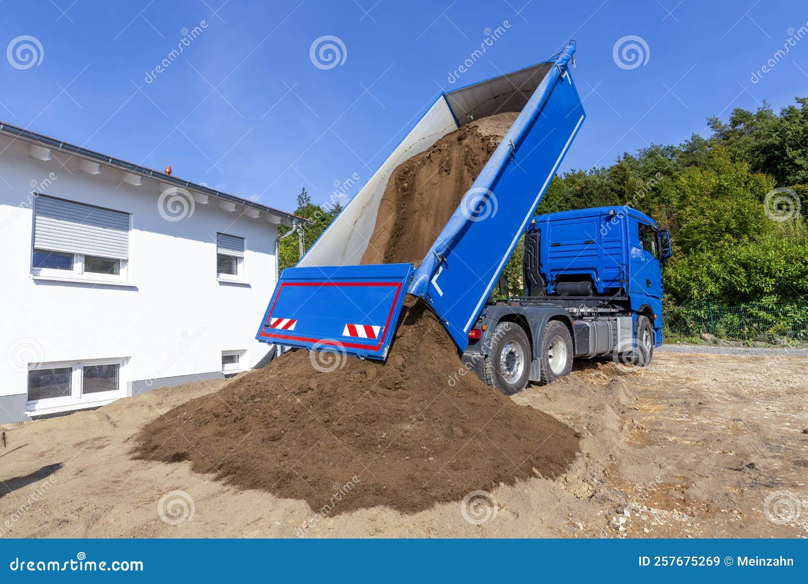 Unloading the Truck with Potting Soil from the Truck Bed at the