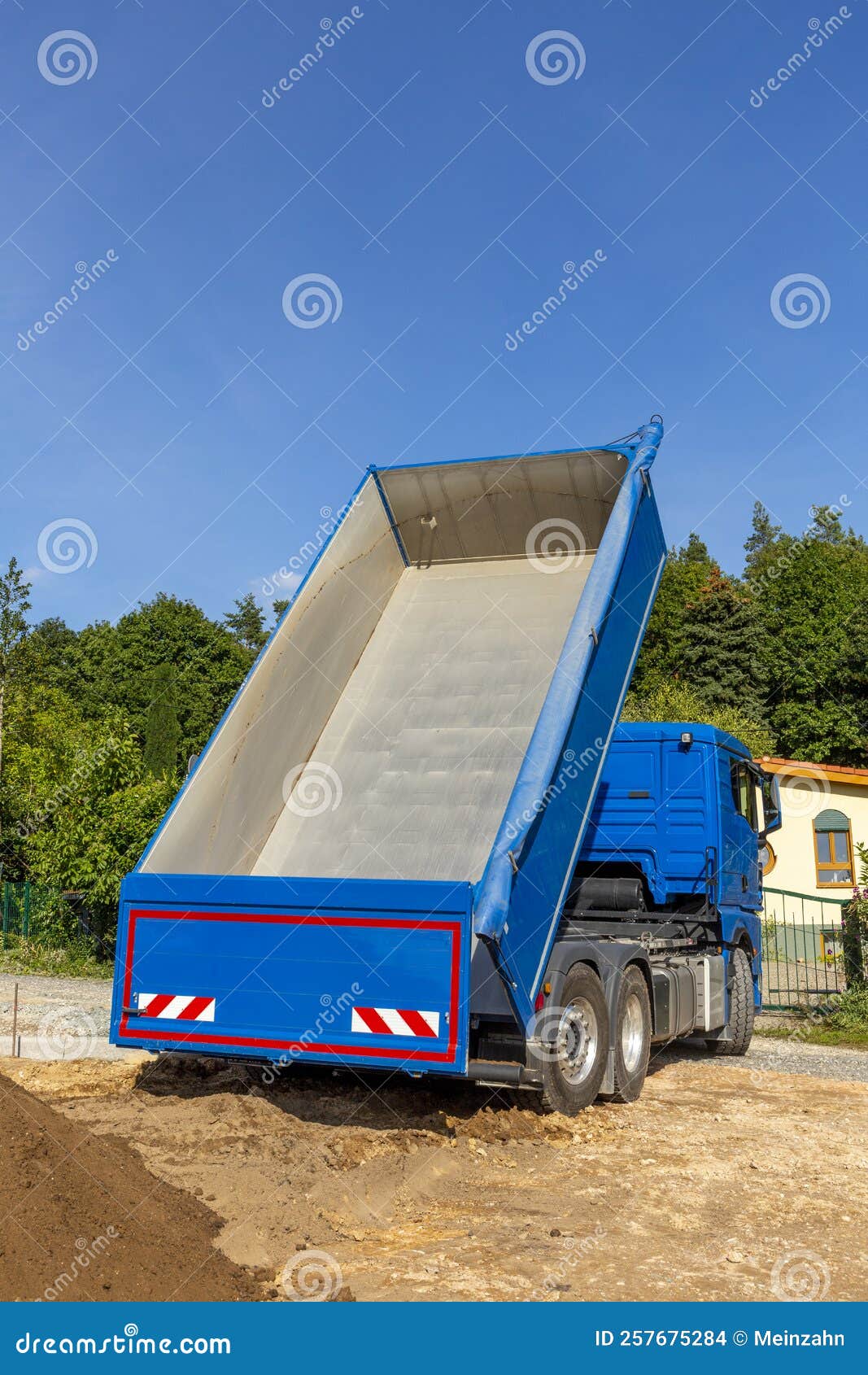 Unloading the Truck with Potting Soil from the Truck Bed at the