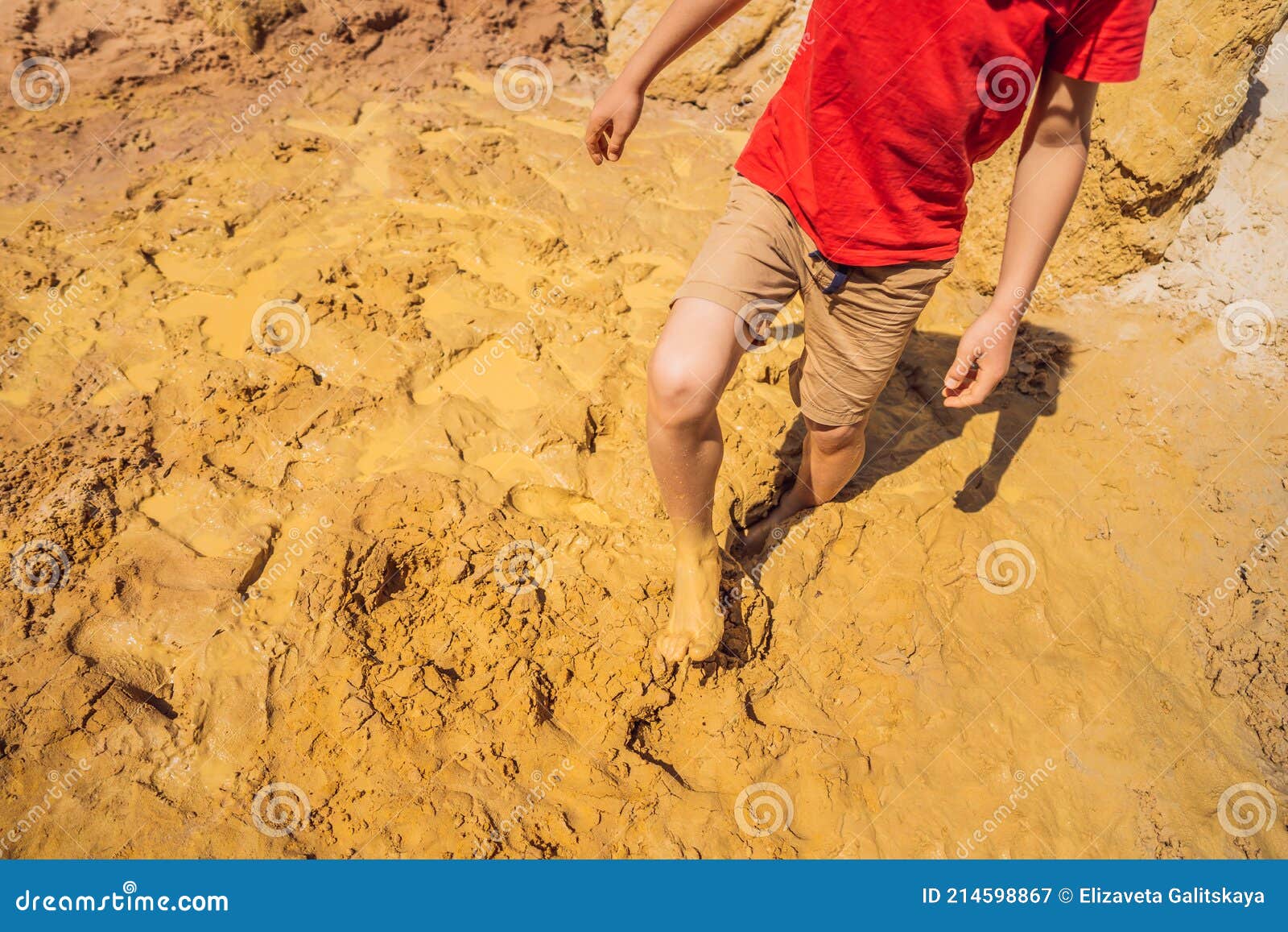 unlucky person standing in natural quicksand river, clay sediments, sinking, drowning quick sand, stuck in the soil