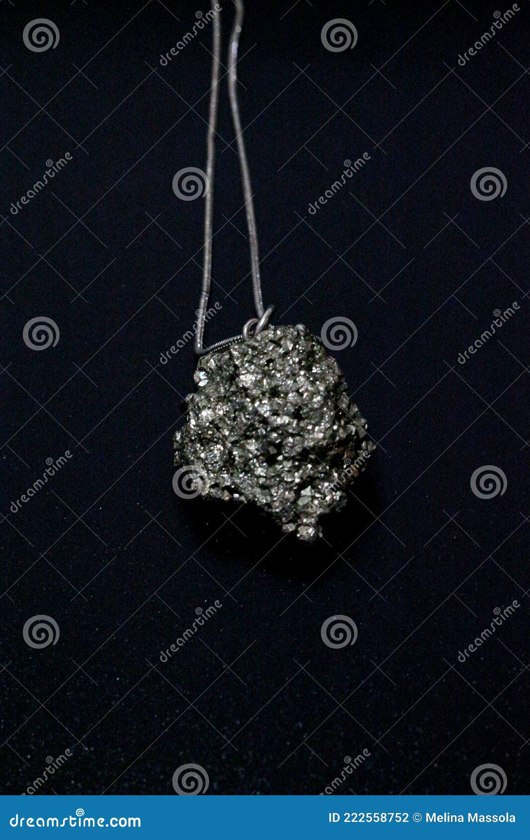 pyrite gem, pyrite stone. necklace on black background. vertical imagem