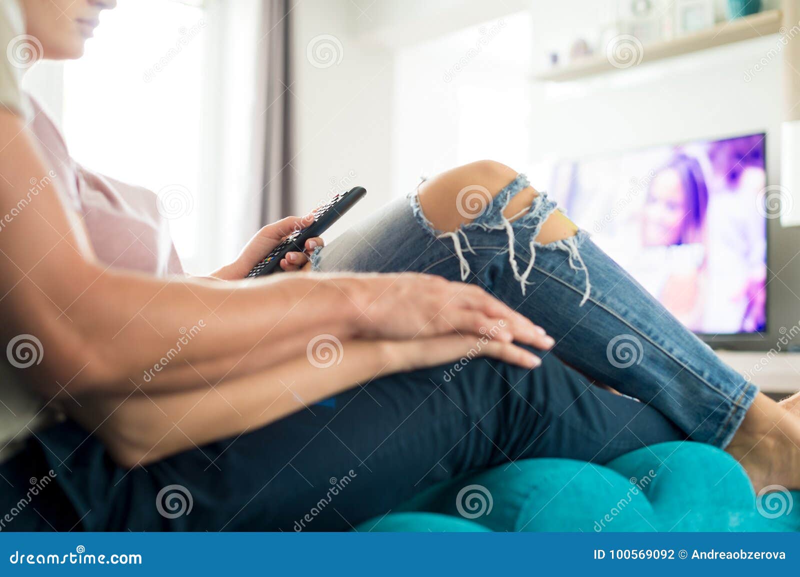 Unrecognisable Loving Couple Watching Television At Their M