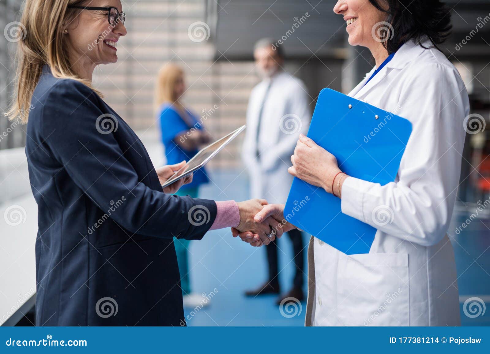 doctor talking to pharmaceutical sales representative, shaking hands.