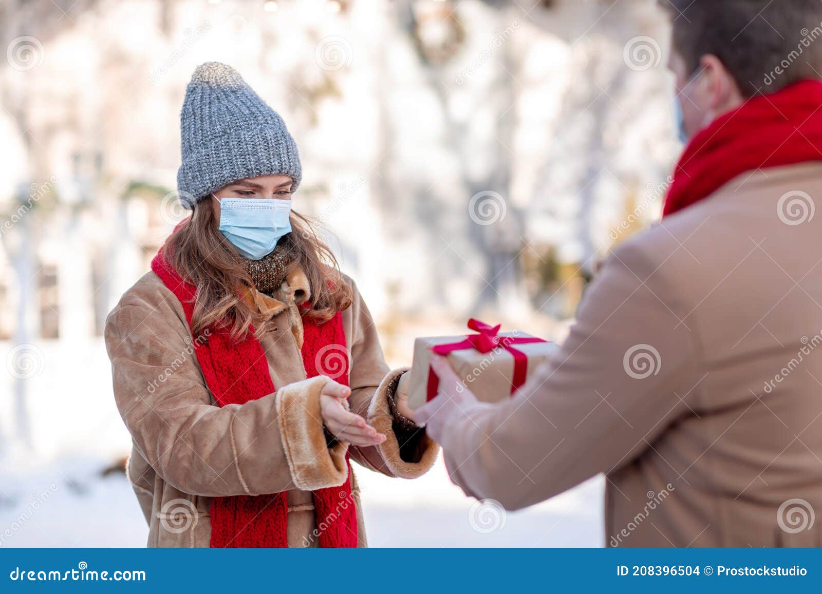 Couple Elderly Female Friends Wearing Face Mask Giving Christmas Present  Stock Photo by ©BasilicoStudioStock 430210076