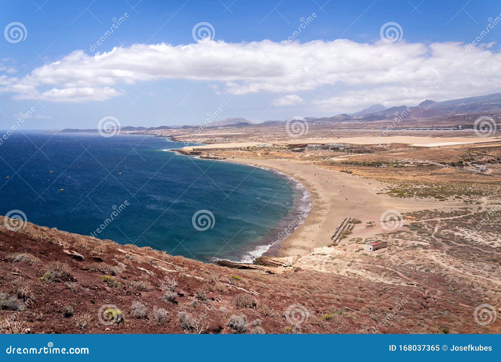 unrecognizable people swimming, sunbathing and walking on la tejita beach in granadilla de abona municipality, el medano, tenerife