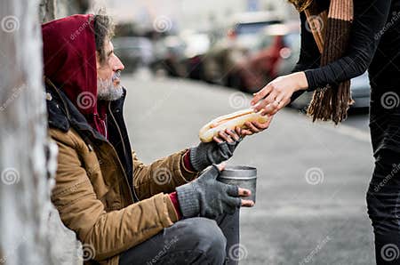 Unrecognizable Woman Giving Food To Homeless Beggar Man Sitting in City ...