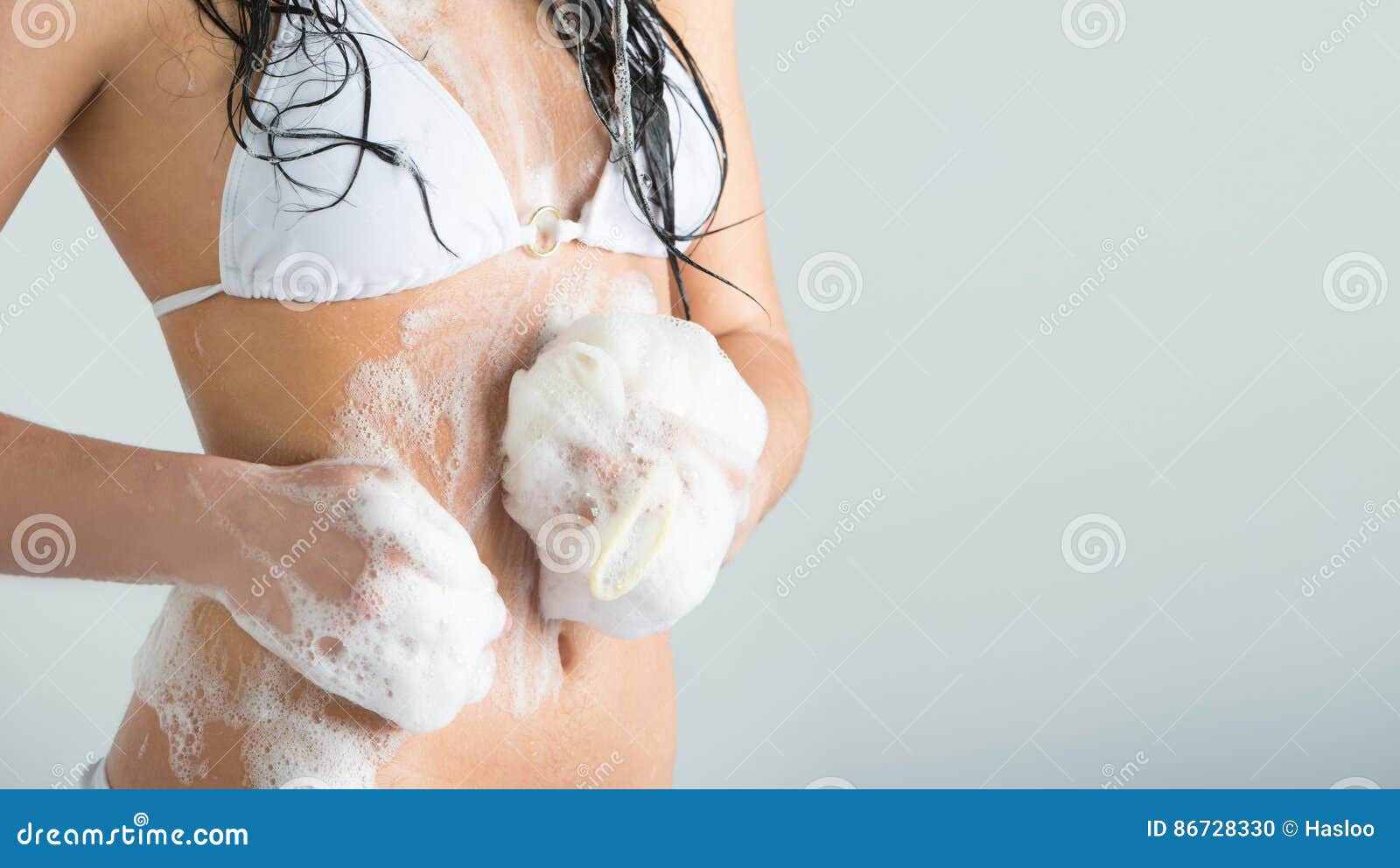 Unrecognizable Woman Washing Herself at Shower with Foam Stock