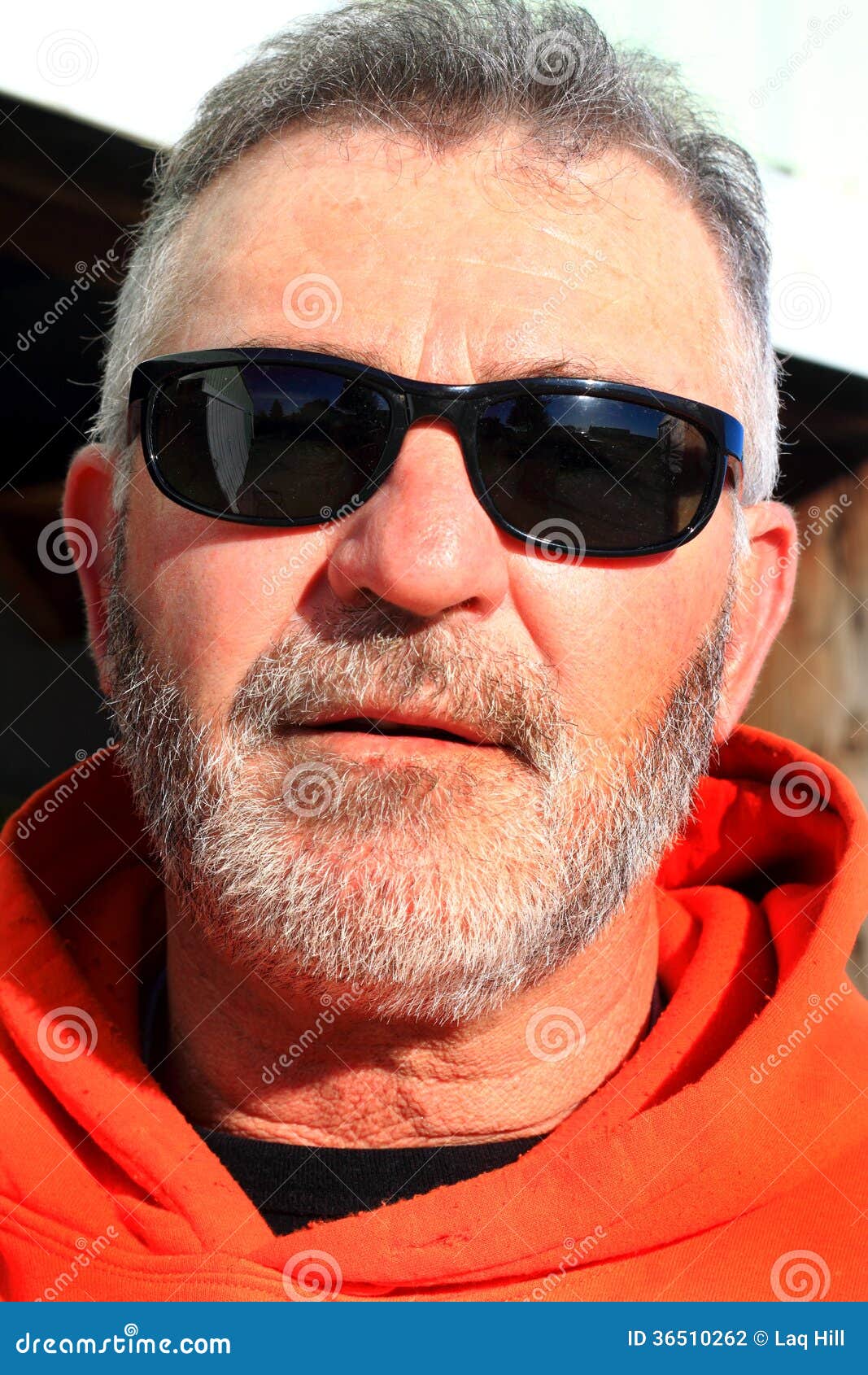 unshaven laborer wearing sunglasses