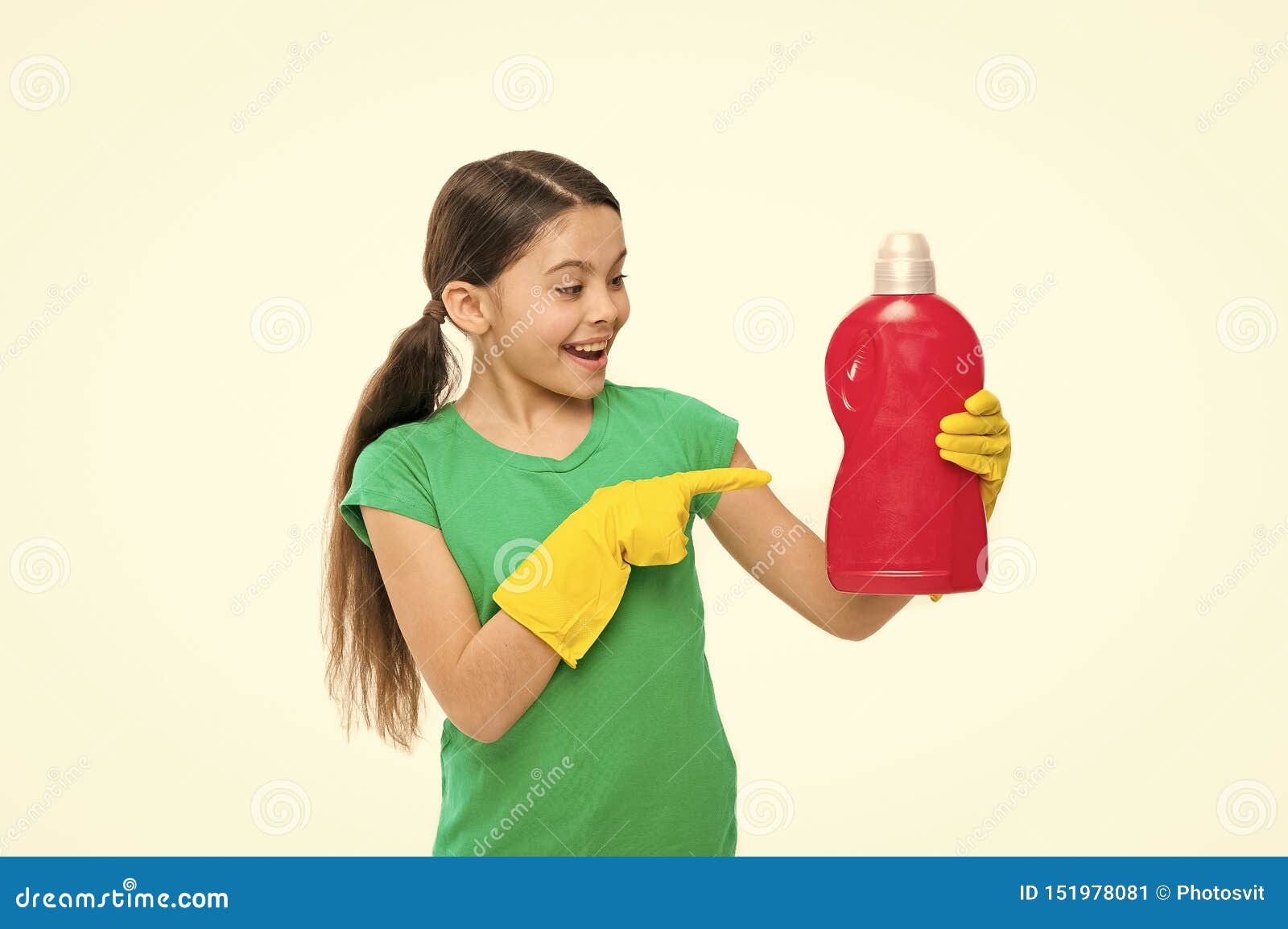 Using household cleaning product. Small housekeeper pointing at detergent bottle. Little child enjoy doing laundry. Cute household helper wearing rubber gloves. Keeping the clothes clean and fresh.