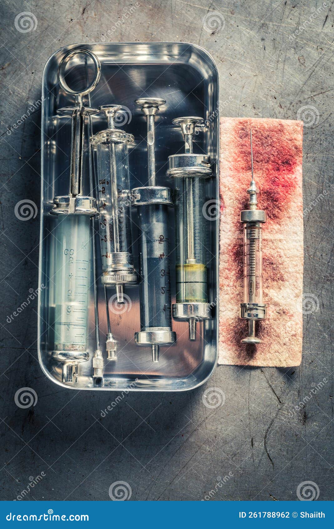 Unusable and Retro Needle and Syringes in Steel Container Stock Photo