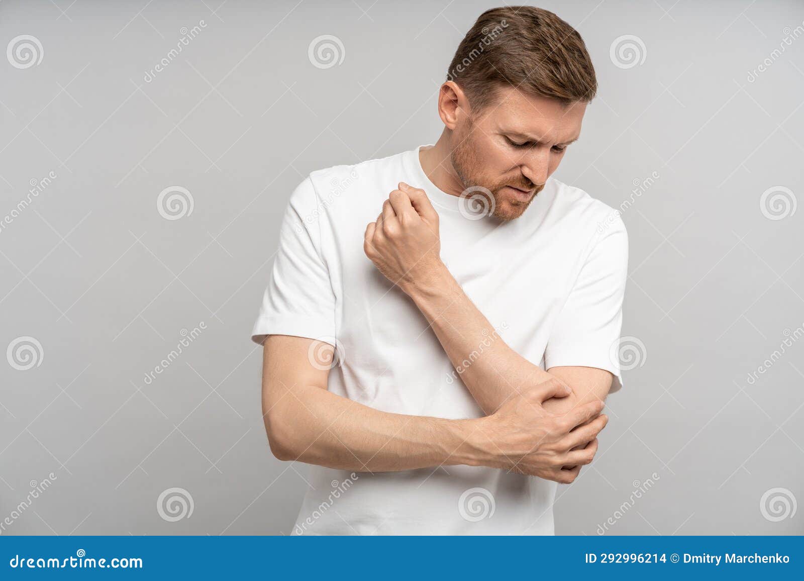 unwell man holding aching elbow sore inflamed bones articulations. studio  on background