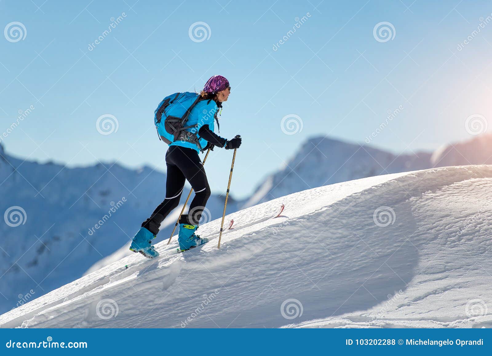 uphill girl with seal skins and ski mountaineering