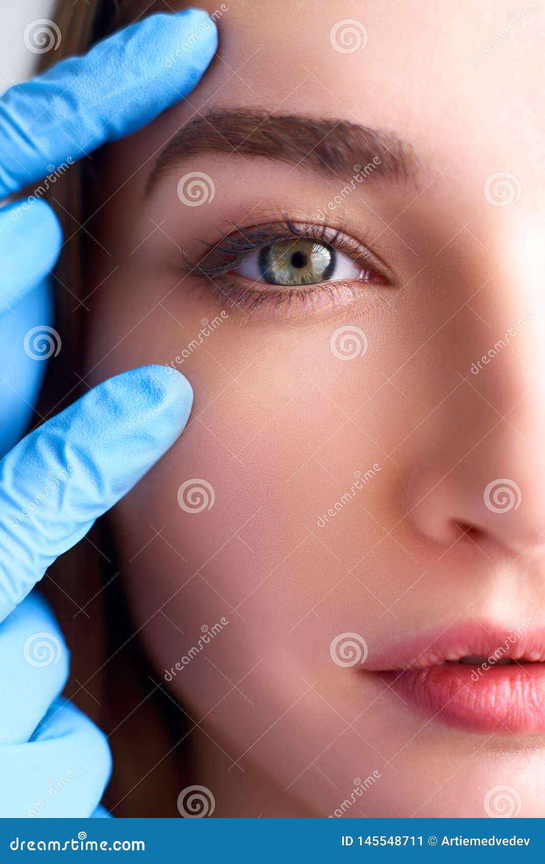 upper eyelid reduction, double eye lid removal plastic surgery concept. beautician doctor hands in gloves touching