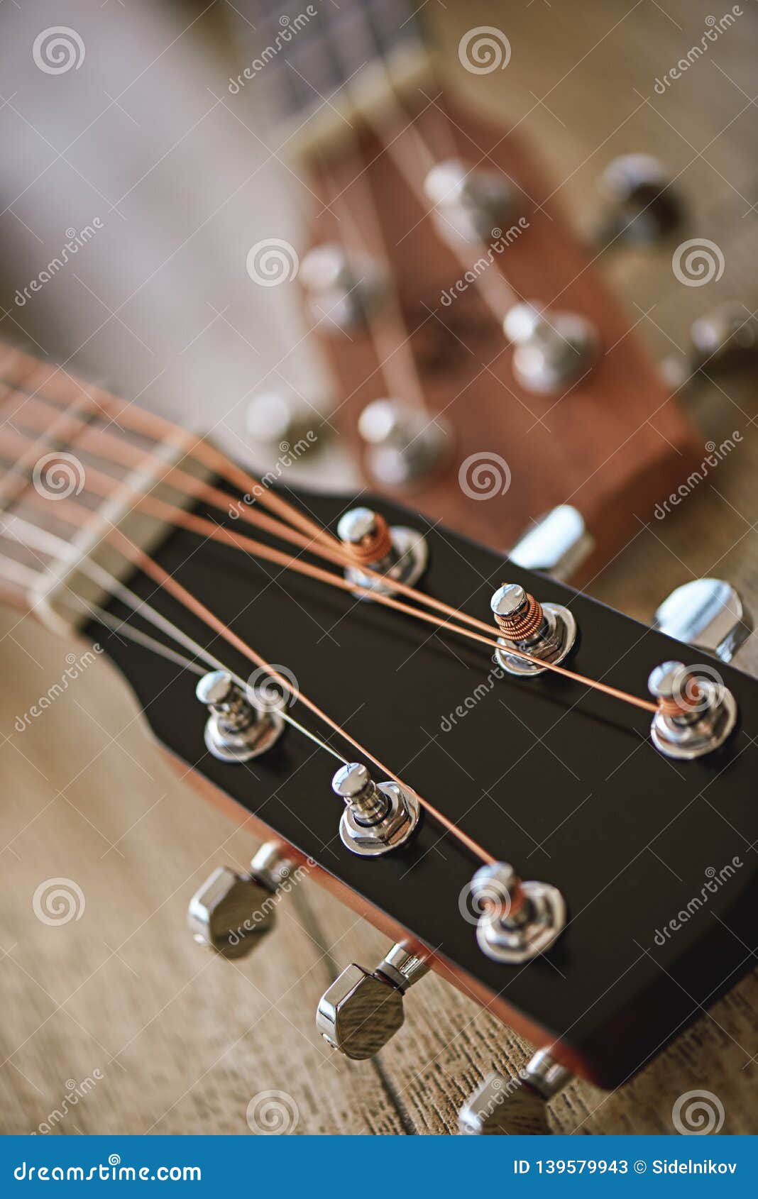Uppermost Part of the Guitar. Vertical Close Up Photo of Guitar Necks