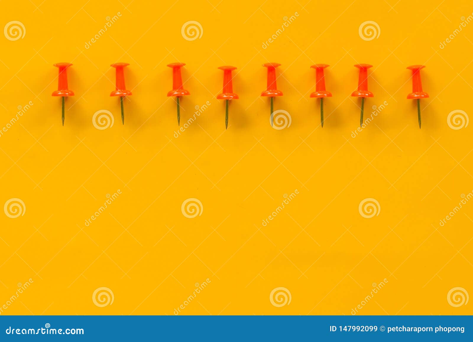 Set of push pins in different colors. Thumbtacks. Top view. on Yellow background space //