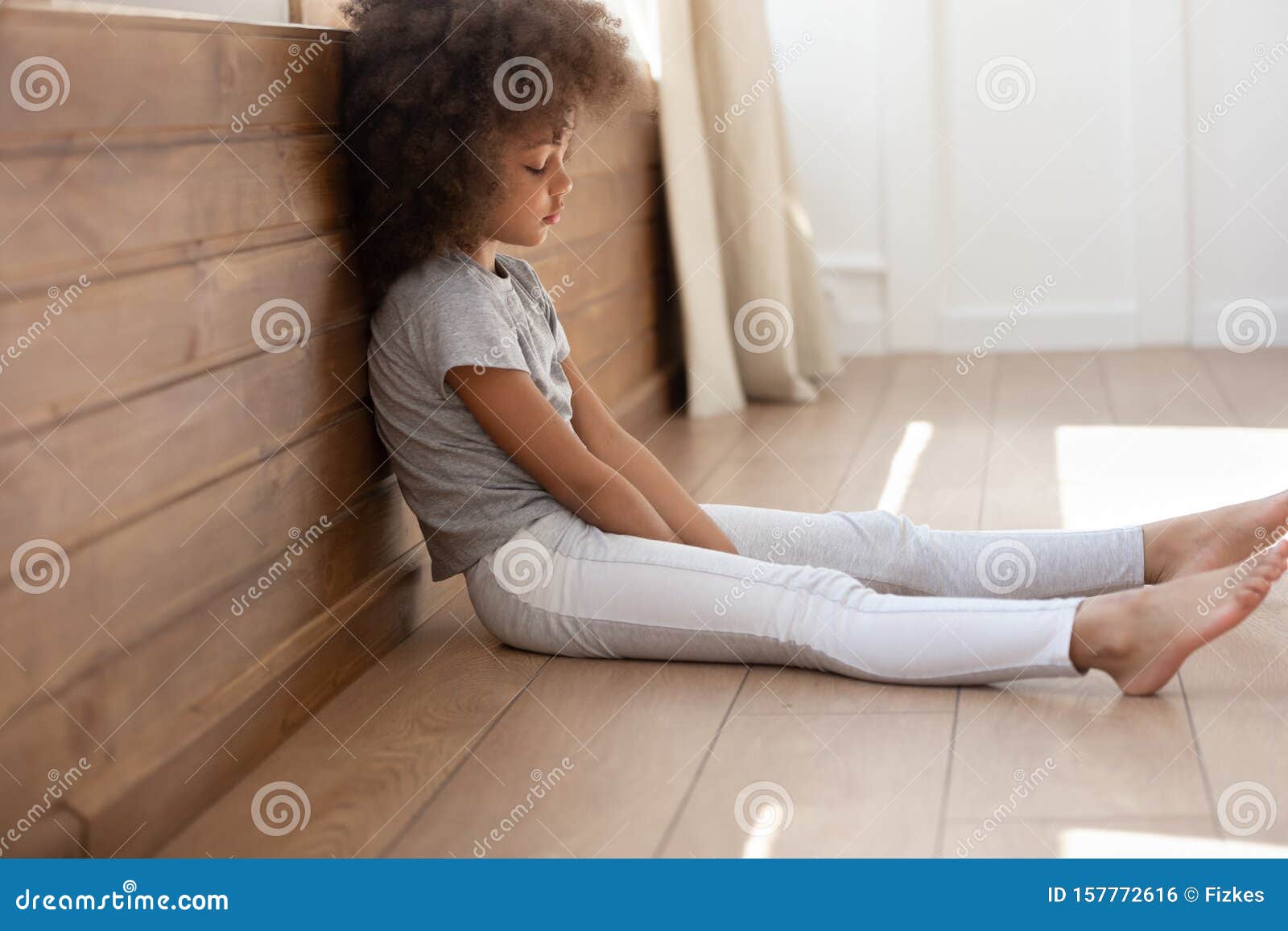 sad little girl sitting alone