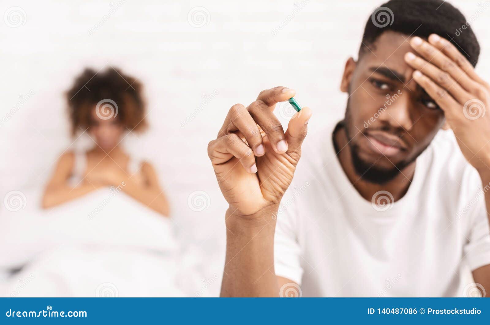 Upset Black Guy Taking Potency Pill before Sex with Girlfriend Stock Photo 